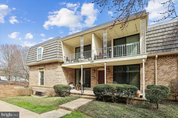 a front view of a house with garden and porch