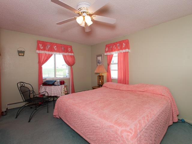 1280 20 Road Fruita, CO 81521 - Photo 28 of 41 a bed room with a bed and a chair