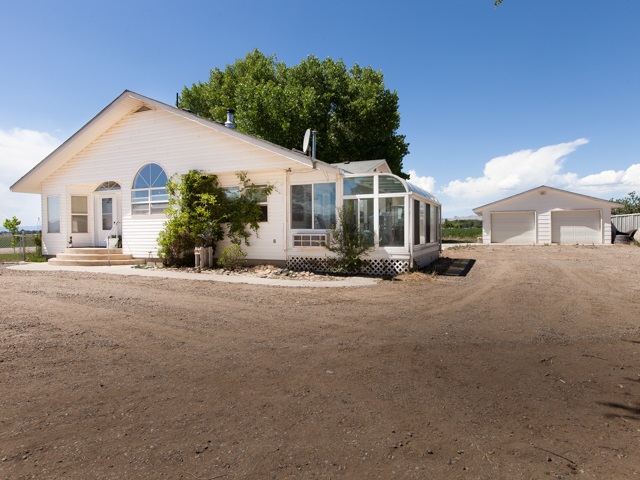 1280 20 Road Fruita, CO 81521 - Photo 3 of 41 a front view of a house with a yard