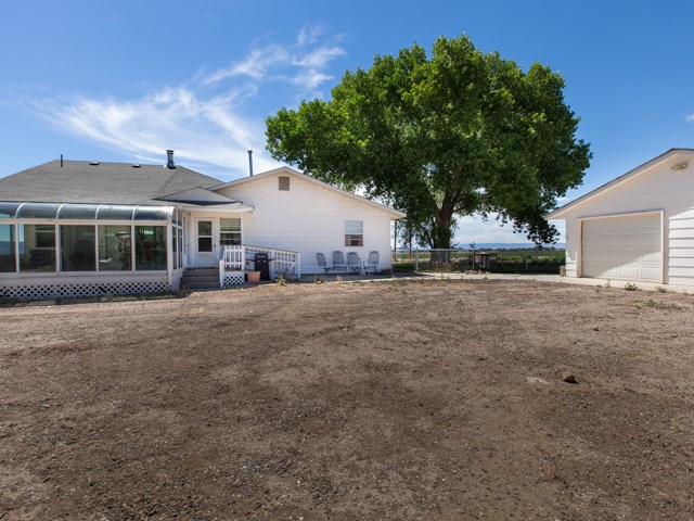 1280 20 Road Fruita, CO 81521 - Photo 5 of 41 a front view of a house with a yard and trees