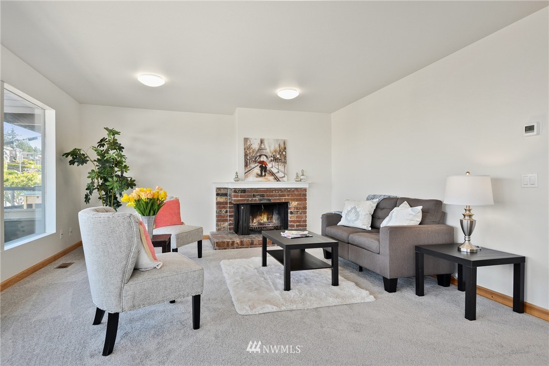 655 Main Street, Unit 204 Edmonds, WA 98020 - Photo 6 of 21 a living room with furniture and a fireplace