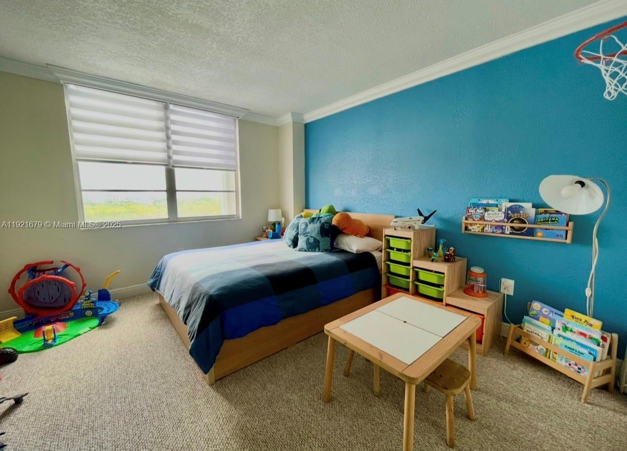 2851 Northeast 183rd Street, Unit 907E Aventura, FL 33160 - Photo 12 of 32 a bedroom with a bed and a window