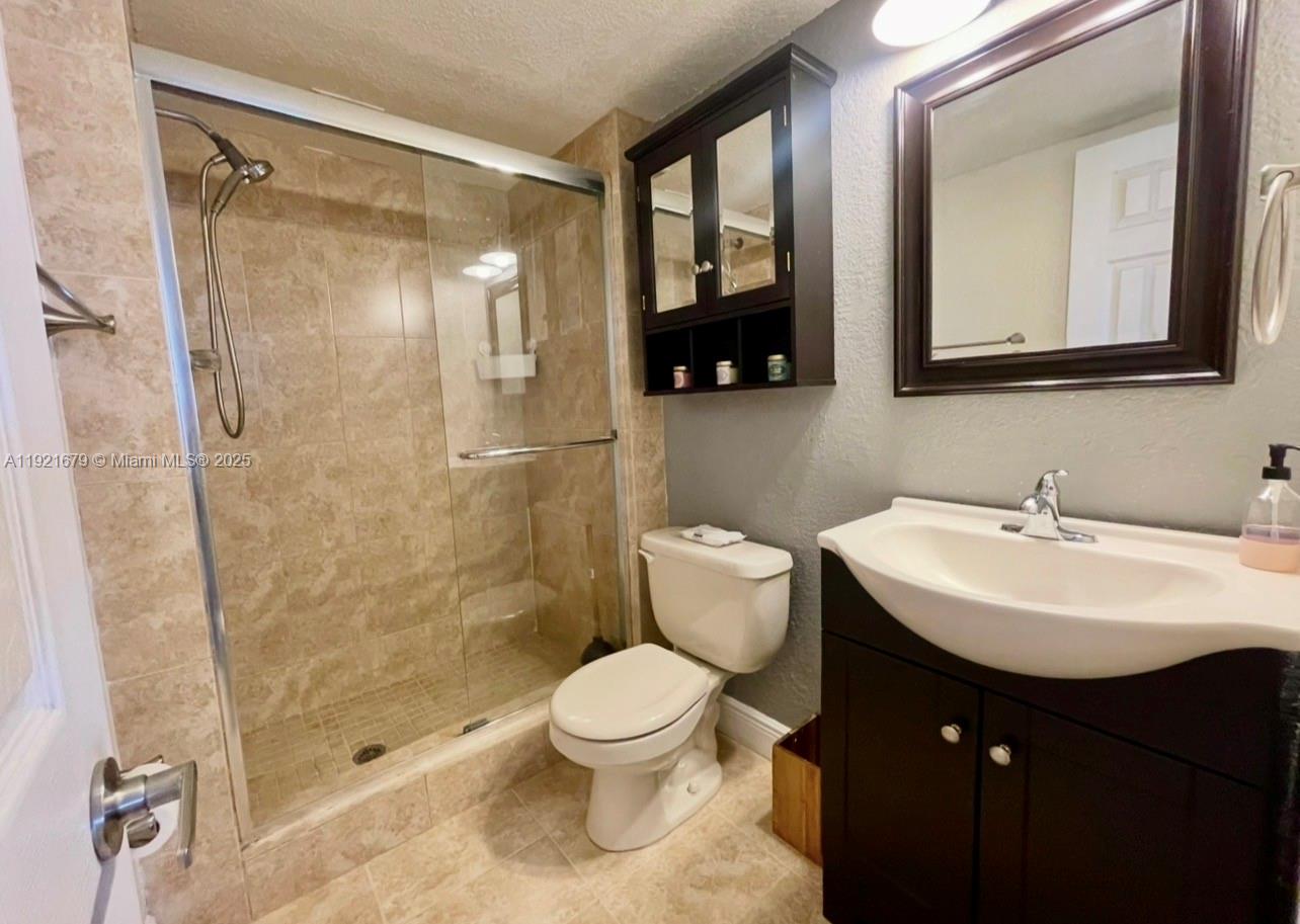 2851 Northeast 183rd Street, Unit 907E Aventura, FL 33160 - Photo 13 of 32 a bathroom with a sink toilet a mirror and shower