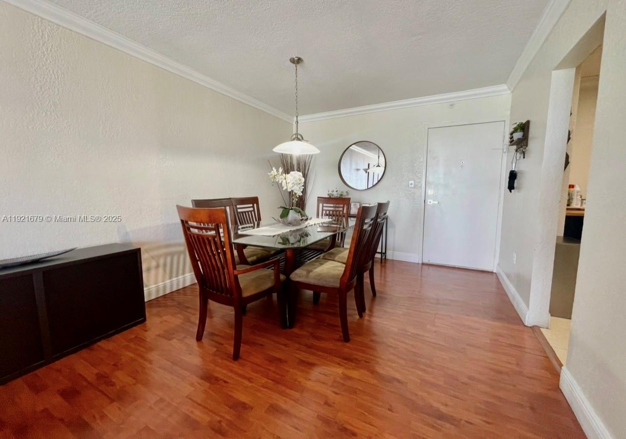 2851 Northeast 183rd Street, Unit 907E Aventura, FL 33160 - Photo 14 of 32 a view of a dining room with furniture and wooden floor