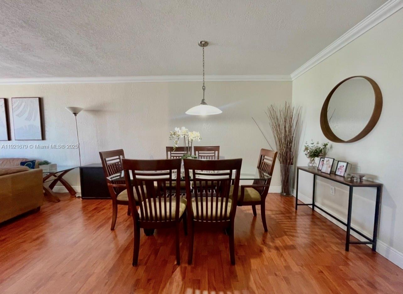 2851 Northeast 183rd Street, Unit 907E Aventura, FL 33160 - Photo 16 of 32 a view of a dining room with furniture and wooden floor