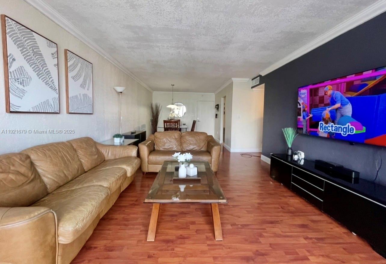 2851 Northeast 183rd Street, Unit 907E Aventura, FL 33160 - Photo 18 of 32 a living room with furniture or couch and a flat screen tv