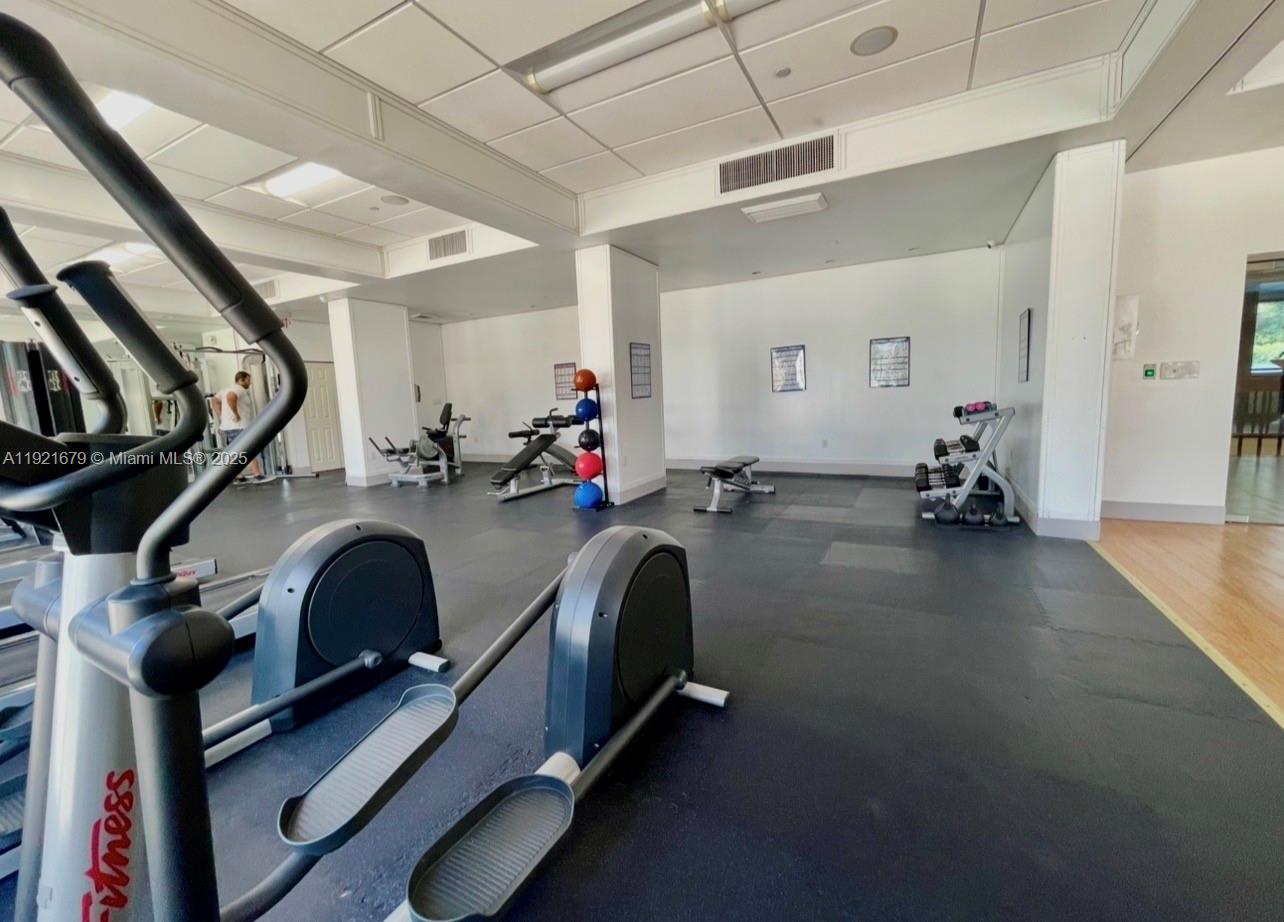 2851 Northeast 183rd Street, Unit 907E Aventura, FL 33160 - Photo 28 of 32 a view of a room with gym equipment