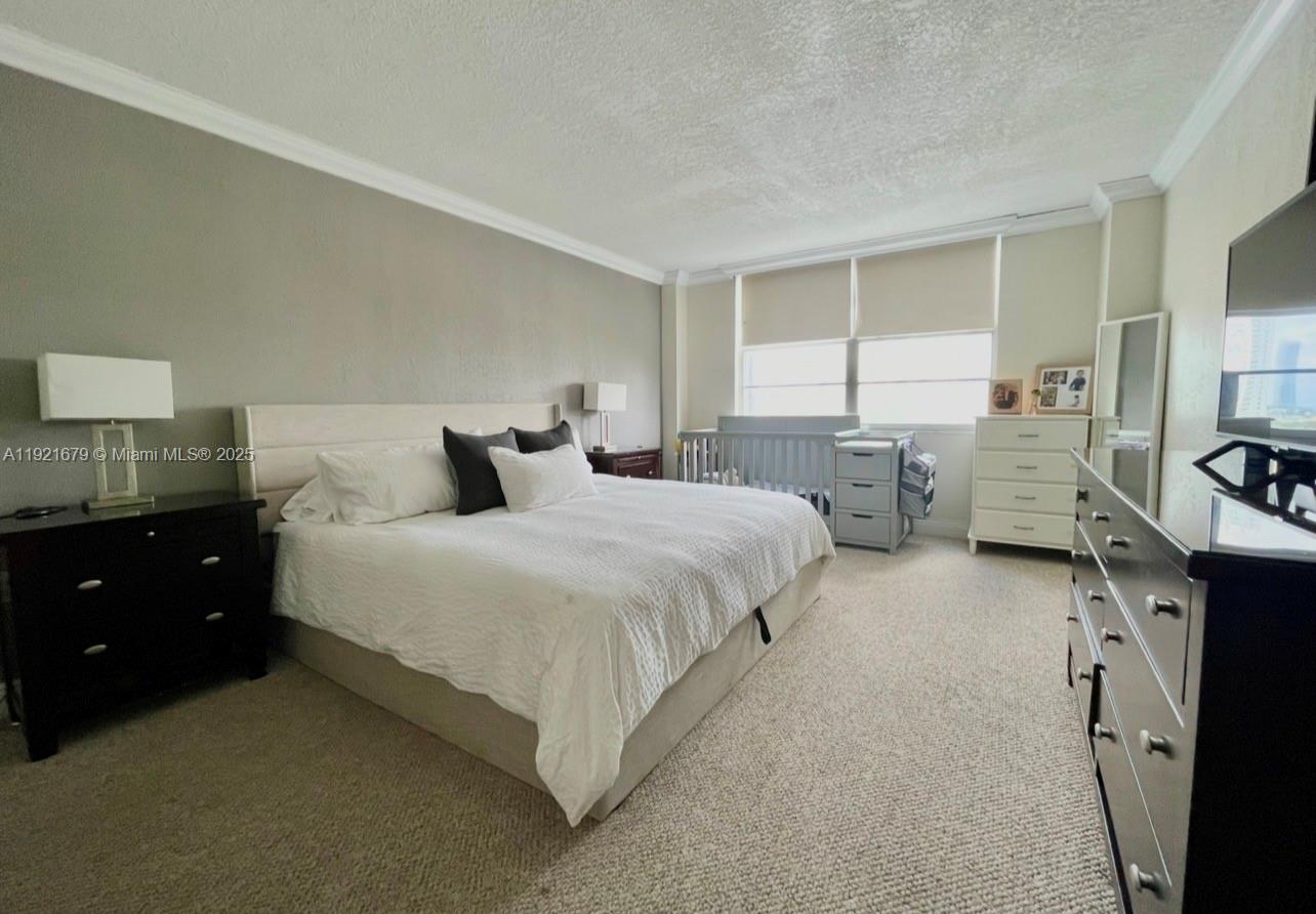 2851 Northeast 183rd Street, Unit 907E Aventura, FL 33160 - Photo 7 of 32 a bedroom with bed and a window