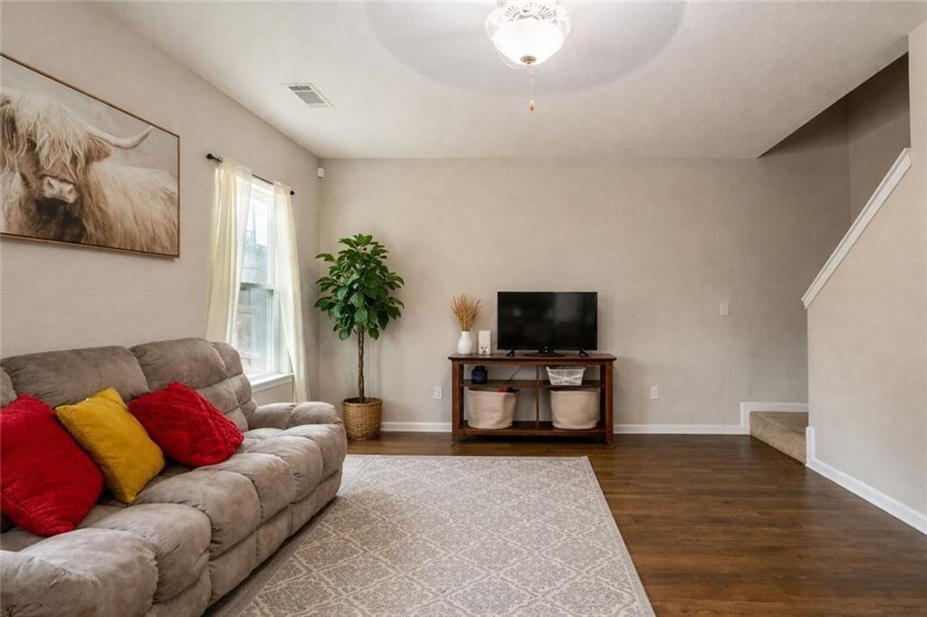 735 Walnut Creek Circle Pendergrass, GA 30567 - Photo 8 of 29 a living room with furniture and a flat screen tv