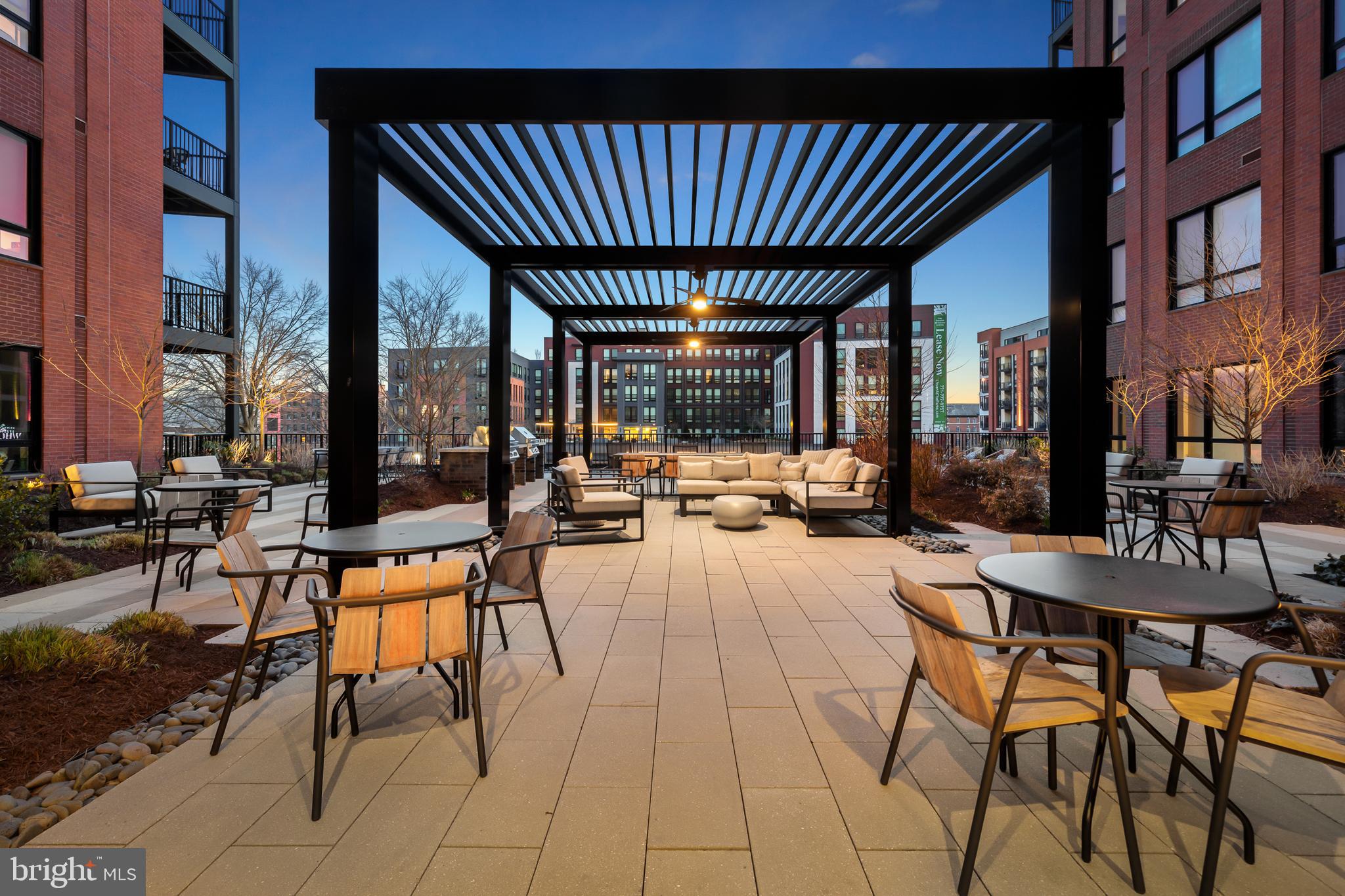 7175 12th Street Northwest, Unit 418 Washington, DC 20012 - Photo 11 of 31 a view of a patio with dining table and chairs