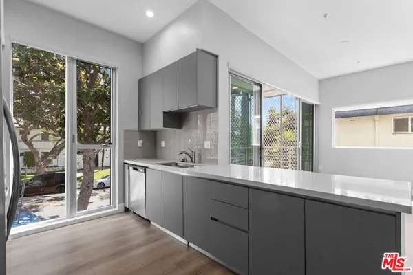 a kitchen with stainless steel appliances a sink stove and cabinets