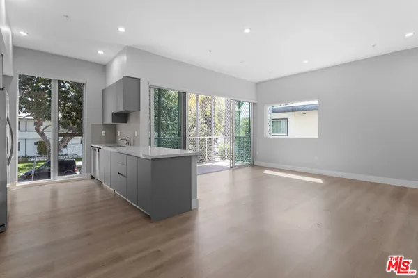 a large room with a large window and wooden floor