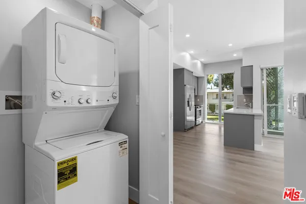 a view of a kitchen with a sink and a large window