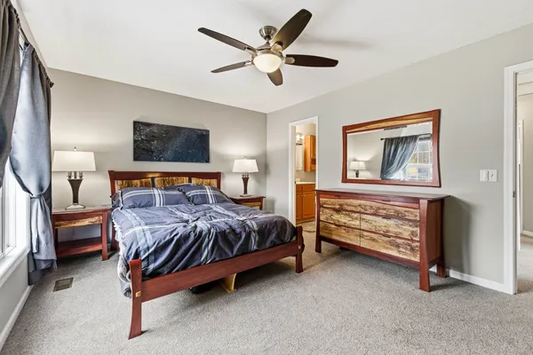 a bed sitting in a room next to a window