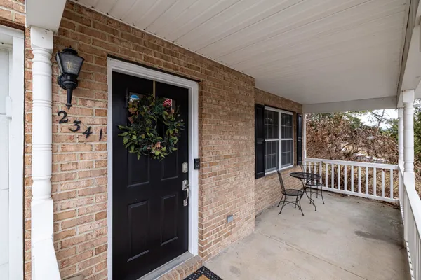 a view of backyard with deck and outdoor seating