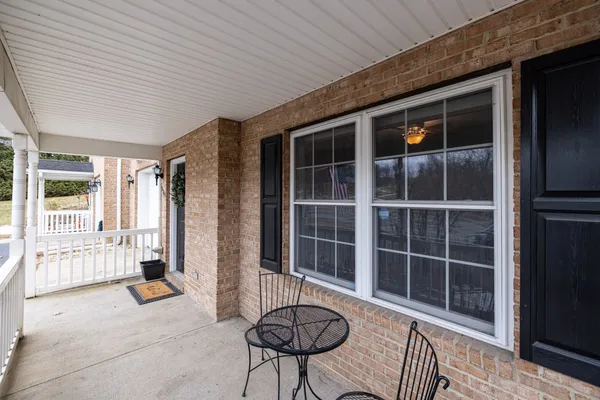 a view of a patio with iron fence