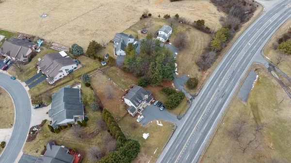 an aerial view of residential houses with outdoor space