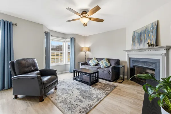 a living room with furniture a flat screen tv and a fireplace