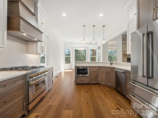 a bathroom with a double vanity sink mirror and toilet