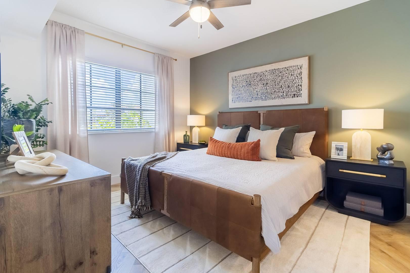 11290 Channing Way, Unit 102 Royal Palm Beach, FL 33414 - Photo 8 of 24 a bedroom with a bed and a chandelier