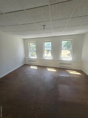 an empty room with a empty space and windows