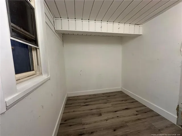 a view of a room with wooden floor and staircase