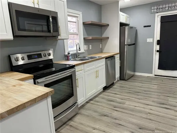 a kitchen with a stove and a microwave