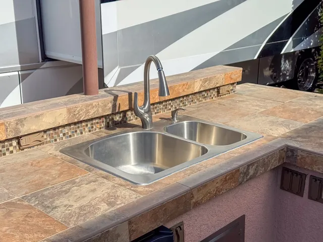 a kitchen with a sink and a mirror