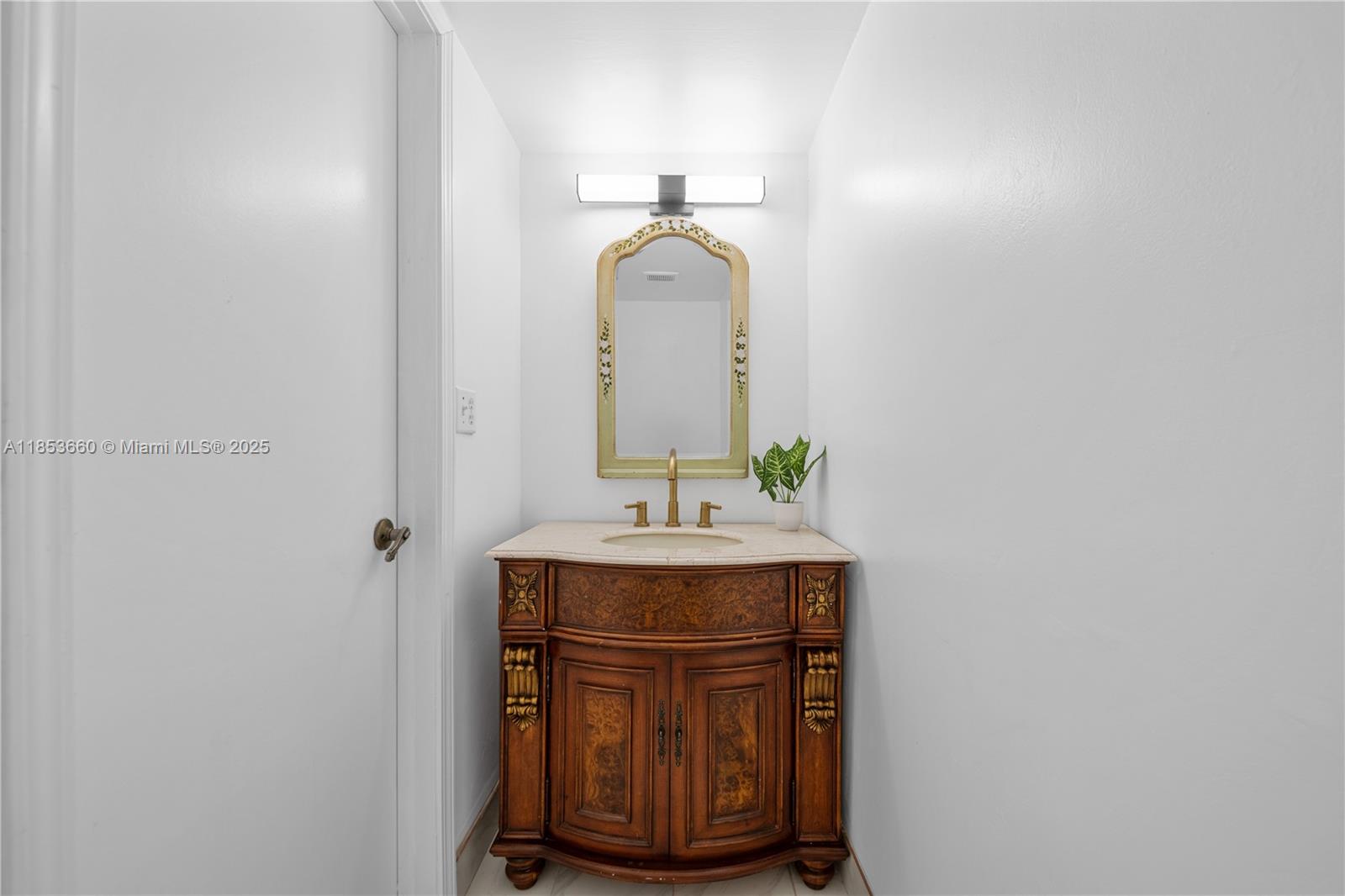 4088 Inverrary Drive, Unit 11F Lauderhill, FL 33319 - Photo 11 of 34 a bathroom with a sink and a mirror