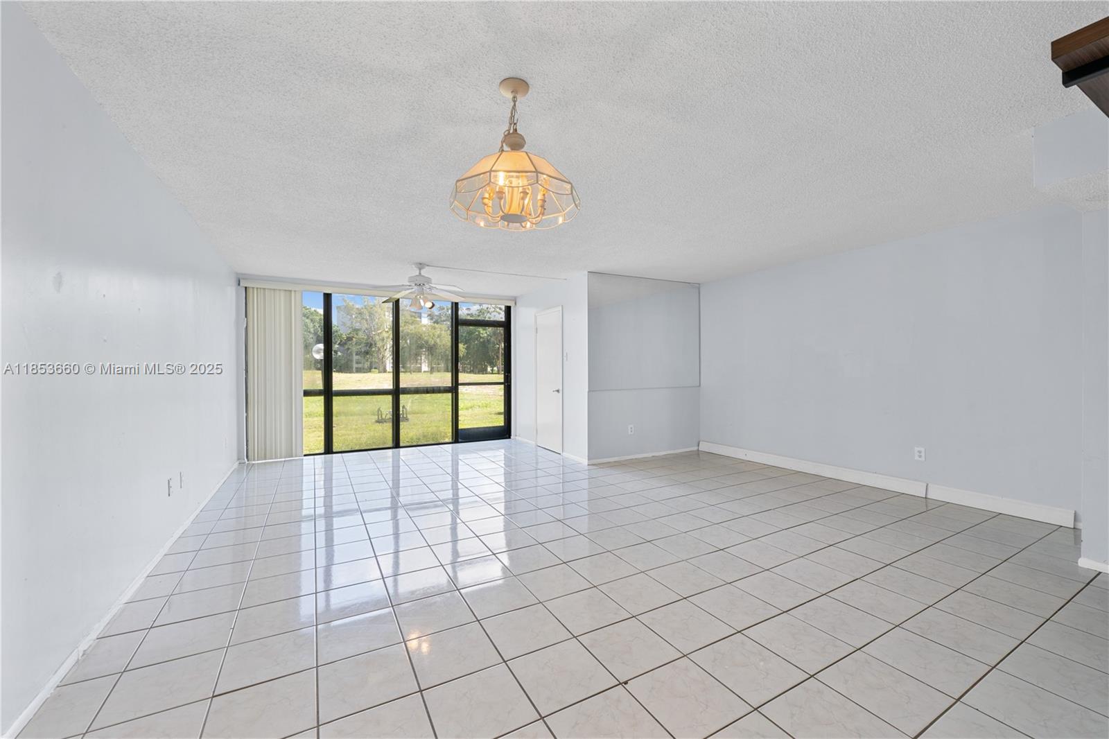 4088 Inverrary Drive, Unit 11F Lauderhill, FL 33319 - Photo 14 of 34 an empty room with windows and fan