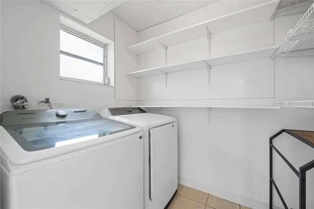 a view of a room with wooden floor and a ceiling fan