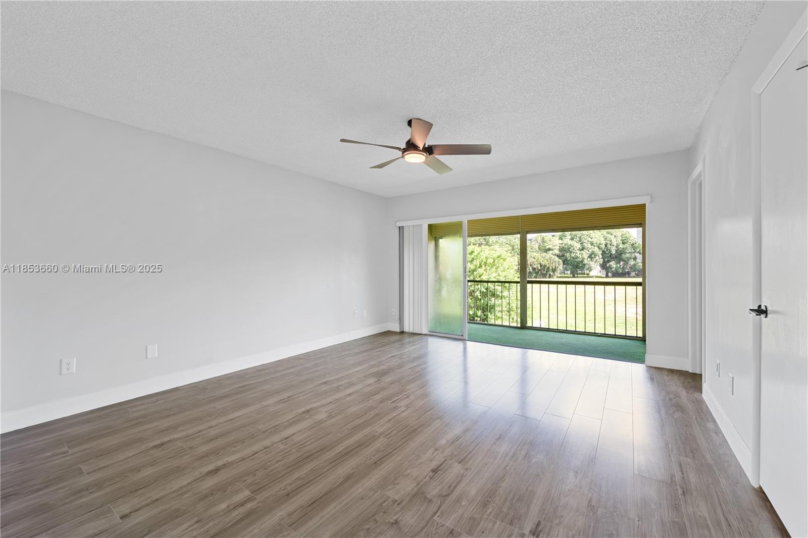 4088 Inverrary Drive, Unit 11F Lauderhill, FL 33319 - Photo 16 of 34 a view of an empty room with wooden floor and a window