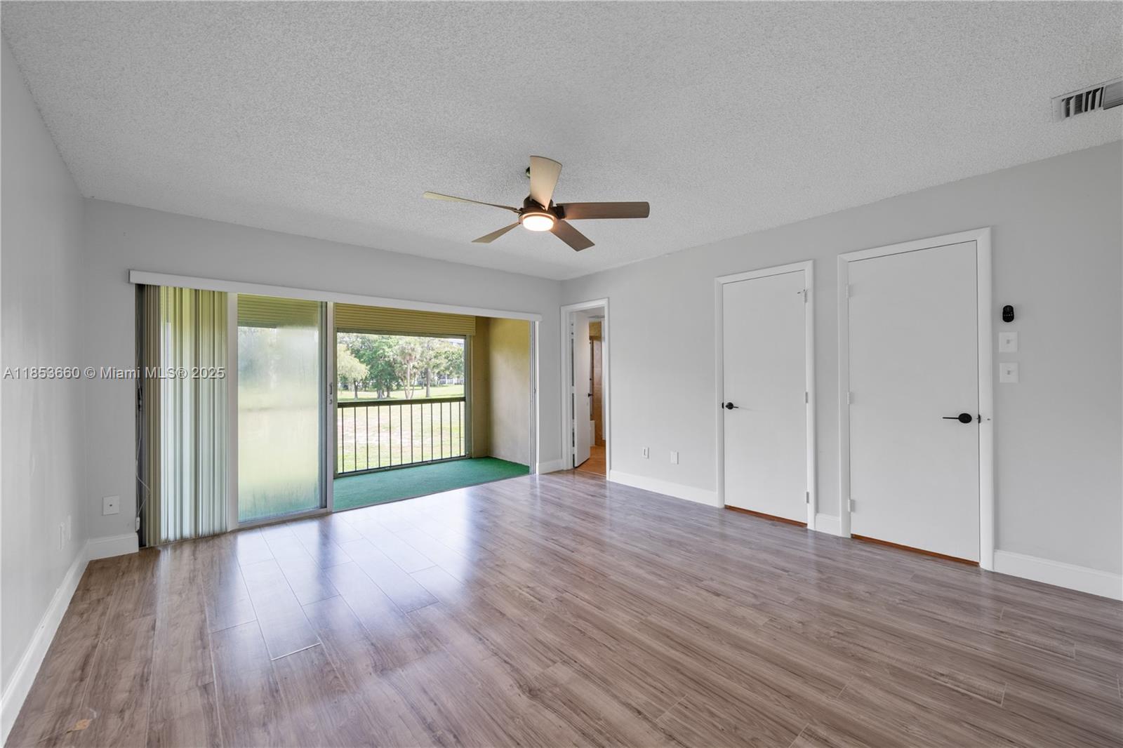 4088 Inverrary Drive, Unit 11F Lauderhill, FL 33319 - Photo 17 of 34 a view of a room with wooden floor and ceiling fan