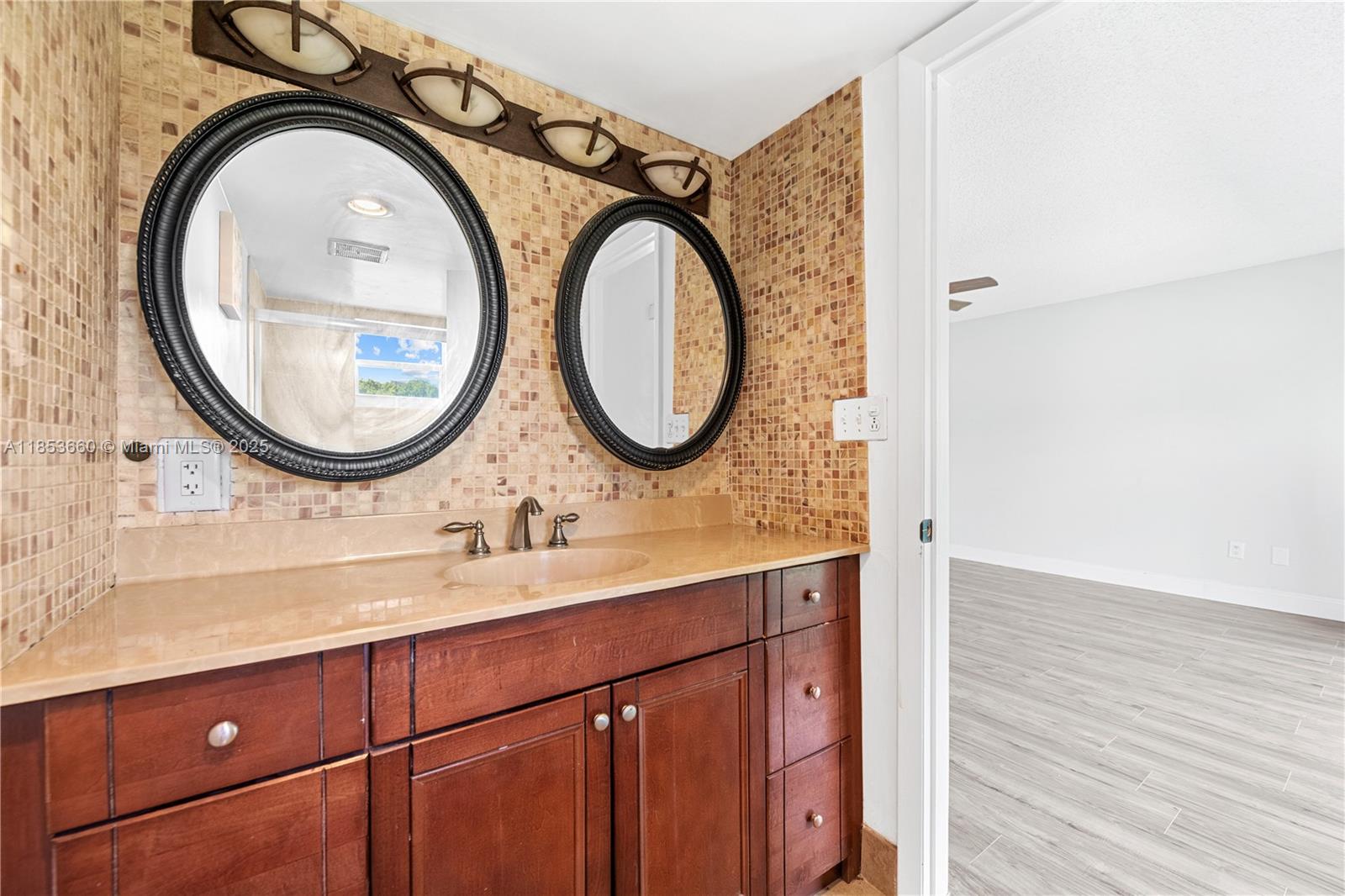 4088 Inverrary Drive, Unit 11F Lauderhill, FL 33319 - Photo 22 of 34 a bathroom with a sink and a mirror