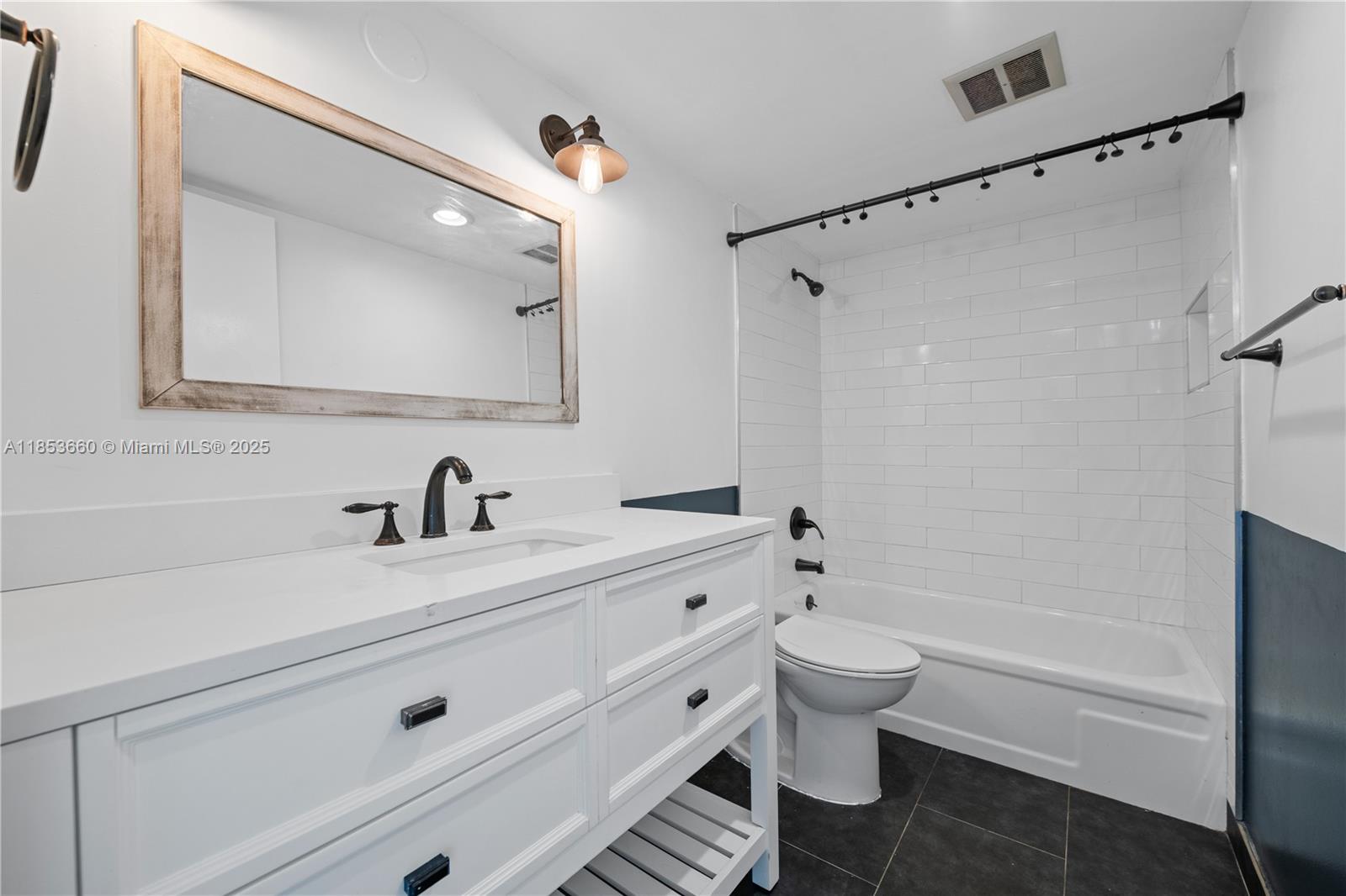 4088 Inverrary Drive, Unit 11F Lauderhill, FL 33319 - Photo 25 of 34 a bathroom with a sink a toilet and a mirror