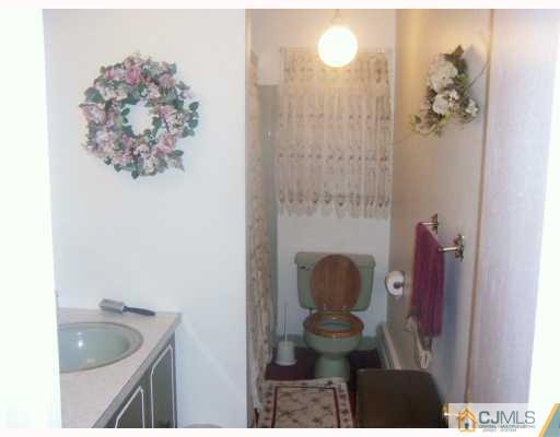 14 Library Place Edison, NJ 08820 - Photo 5 of 8 a bathroom with a sink and mirror with bathtub