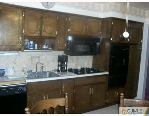 14 Library Place Edison, NJ 08820 - Photo 6 of 8 a kitchen with a sink and cabinets