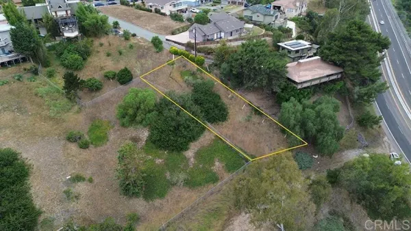 an aerial view of residential house with outdoor space and trees all around
