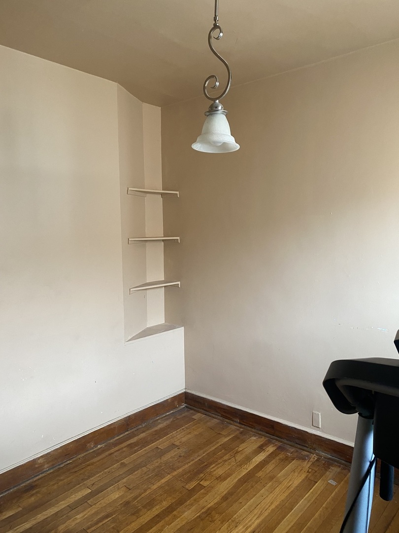 6549 South Bishop Street Chicago, IL 60636 - Photo 11 of 18 a view of empty room with wooden floor and fan