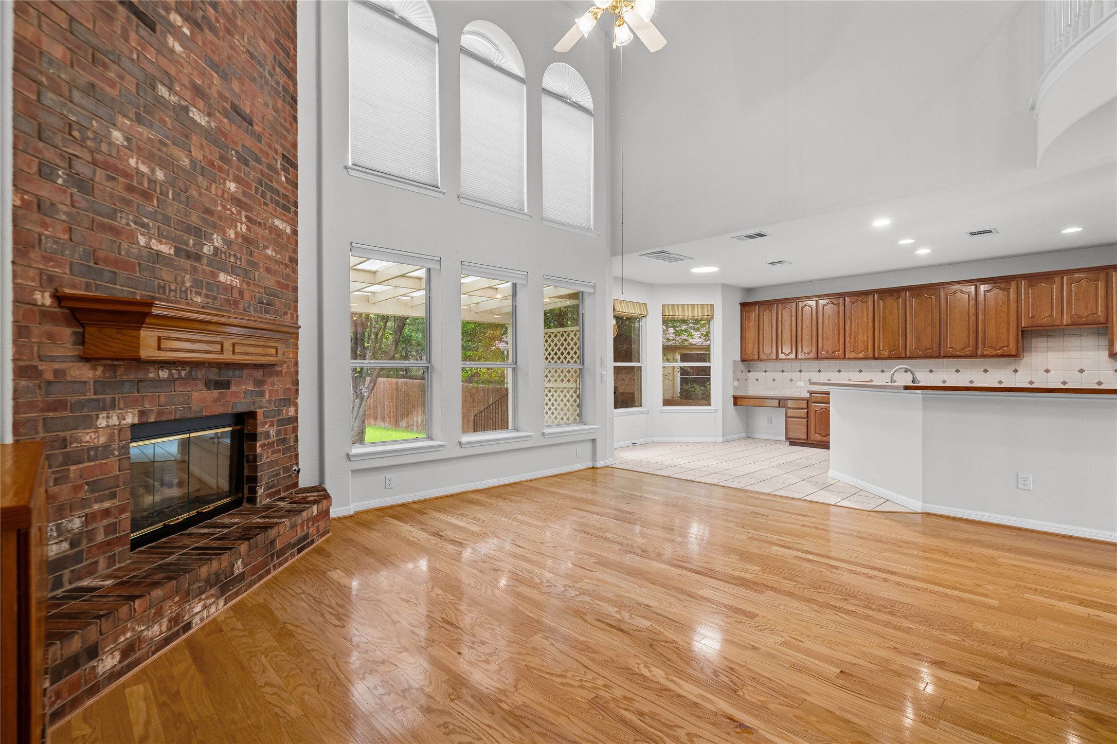 10700 Pointe View Drive Austin, TX 78738 - Photo 9 of 35 A spacious living area featuring a striking brick fireplace and gleaming hardwood floors.