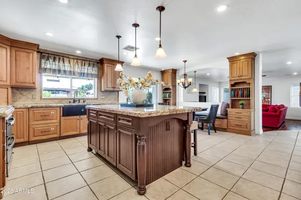 a kitchen with granite countertop white cabinets stainless steel appliances and a sink
