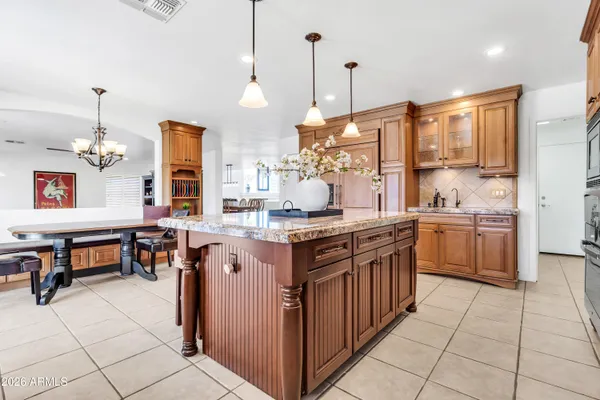 a kitchen with stainless steel appliances granite countertop a sink and cabinets