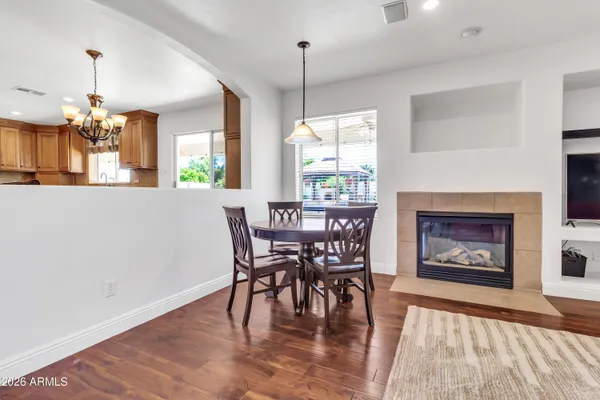 a living room with furniture fireplace and a large window