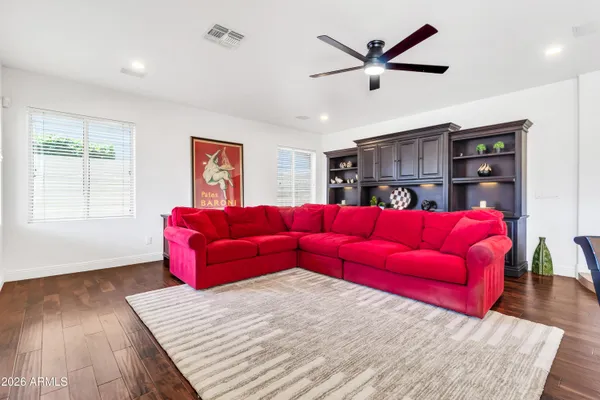a bedroom with a bed chandelier and a window