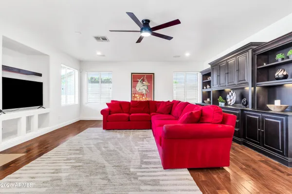 a living room with furniture a flat screen tv and a large window