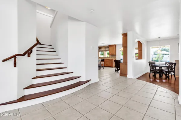 a living room with wooden floor and white walls