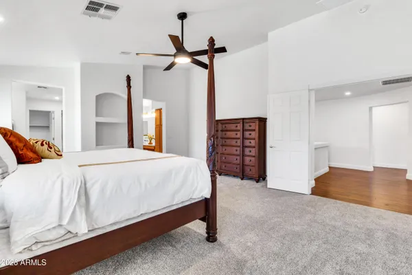 a bedroom with a bed and a dresser