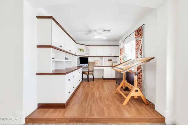 a room with pool table and windows
