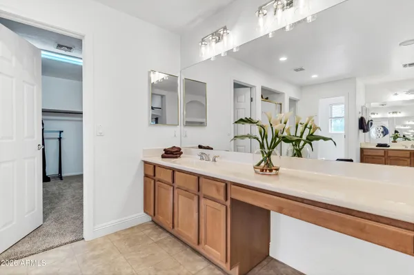 a bathroom with a sink a vanity and a mirror