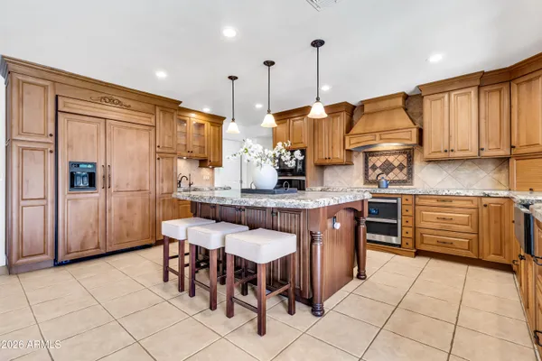 a front view of a house with a yard and potted plants
